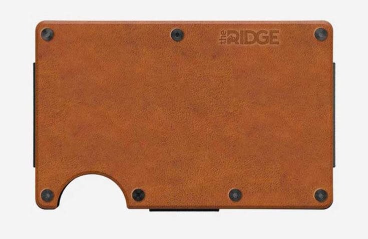 A minimalist, slim wallet made of brown leather with a durable design, featuring "The Ridge" branding engraved in the top right corner.