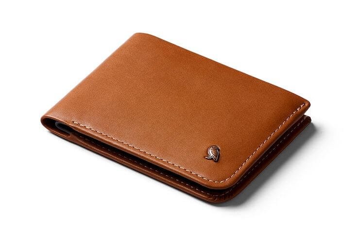 Brown Bellroy Slim Sleeve Wallet made of premium leather, featuring a minimalist design with a smooth, elegant finish. The wallet is compact and slim, designed to hold cards and cash with ease, including quick-access card slots and a hidden compartment for bills.